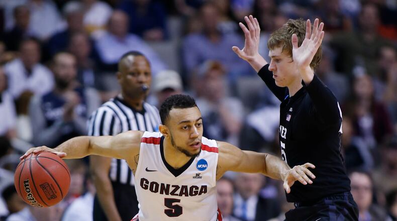 Gonzaga guard Nigel Williams-Goss (5) is defended by Xavier guard J.P. Macura during the second half of an NCAA Tournament college basketball regional final game Saturday, March 25, 2017, in San Jose, Calif. (AP Photo/Tony Avelar)