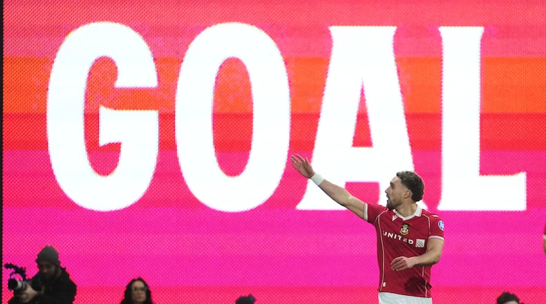 Wrexham's Sam Smith celebrates after scoring during the fifth round FA Cup soccer match between Wrexham and Chelsea in Wrexham, Wales, Saturday, March 7, 2026. (AP Photo/Jon Super)