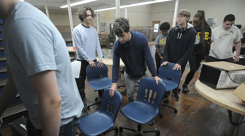 Kettering students help move chairs Tuesday, May 14, 2024. Kettering City Schools is renovating Fairmont High School’s Career Technology Center with a $1.24 million addition for an advanced manufacturing program. MARSHALL GORBY\STAFF