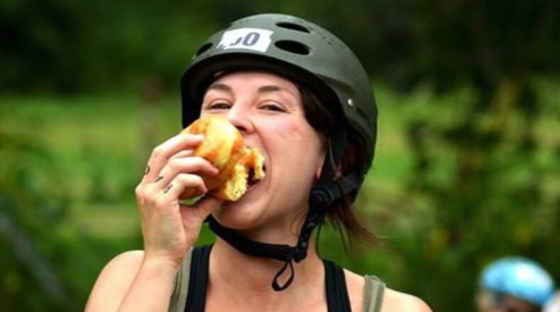 A participant in a previous Tour De Donut gets into the spirit of the event by downing a donut. CONTRIBUTED