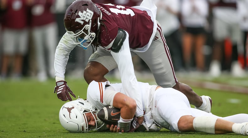 Mississippi State linebacker Derion Gullette, top, sacks Texas quarterback Arch Manning, bottom, during the first half of an NCAA college football game in Starkville, Miss., Saturday, Oct. 25, 2025. (AP Photo/James Pugh)