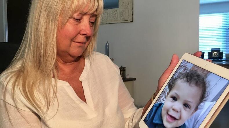 Lucy Ashburn poses with a photo of her 2-year-old grandson Kaeden, who was was taken to Dayton Children s Medical Center for severe scalding burns over a significant portion of his body, last year caused by his stepfather who was sentenced on Friday. (Chuck Hamlin/STAFF PHOTO)