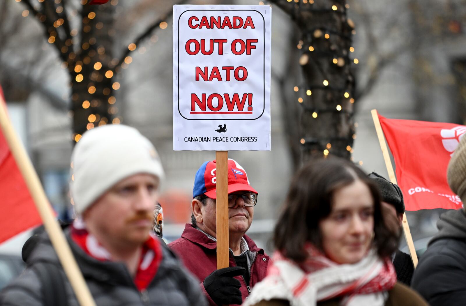 People take part in a protest against NATO in Montreal, Saturday, Nov. 23, 2024. (Graham Hughes/The Canadian Press via AP)