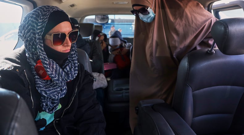 Family members of suspected Islamic State militants who are Australian nationals board a van heading to the airport in Damascus during the first repatriation operation of the year, at Roj Camp in eastern Syria, Monday, Feb. 16, 2026. Thirty-four Australian citizens from 11 families departed the camp. (AP Photo/Baderkhan Ahmad)