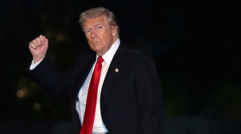 President Donald Trump gestures while walking across the South Lawn of the White House, Sunday, Nov. 2, 2025, in Washington, after returning from a trip to Florida. (AP Photo/Mark Schiefelbein)