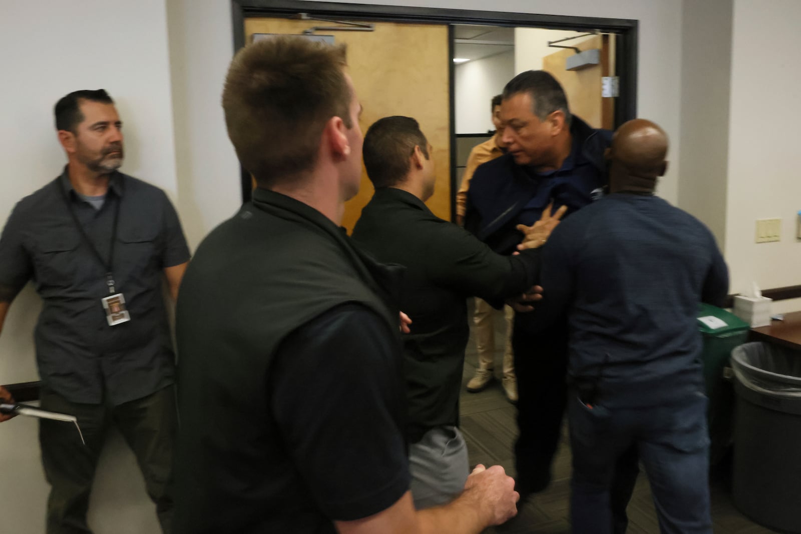 U.S. Sen. Alex Padilla is pushed out of the room as Homeland Security Secretary Kristi Noem holds a news conference regarding the recent protests in Los Angeles on Thursday, June 12, 2025. (AP Photo/Etienne Laurent)