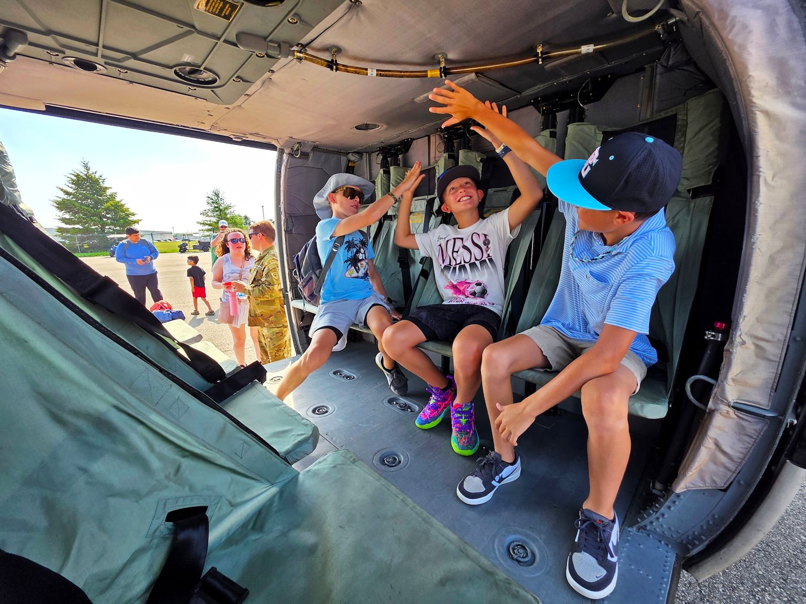 Weston Kennedy, 14, left, Warren Kennedy, 10, middle, and Jordan Wayne, 10, sit inside a U.S. Army Blackhawk helicopter during the CenterPoint Energy Dayton Air Show Saturday, June 21, 2025 at Dayton International Airport. NICK GRAHAM/STAFF