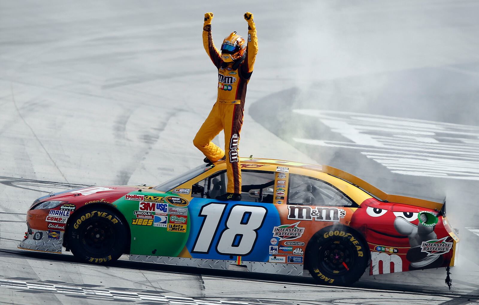 FILE - Kyle Busch celebrates after winning the NASCAR Sprint Cup Series auto race at Bristol Motor Speedway on March 20, 2011 in Bristol, Tenn. (AP Photo/Wade Payne, file)