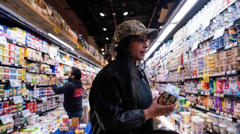 Kashish Ali shops for groceries before filling a One Love Community Fridge, Nov. 15, 2025, in Brooklyn, New York. (AP Photo/Adam Gray)