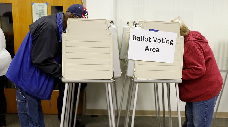 People cast their votes at a Springfield election poll Tuesday. Bill Lackey/Staff