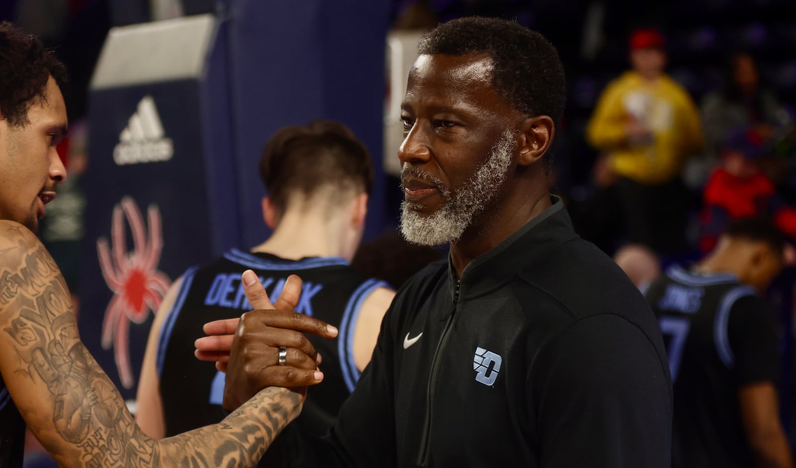 Dayton's Anthony Grant, right, hugs De'Shayne Montgomery after a victory against Richmond on Tuesday, March 3, 2026, at the Robins Center in Richmond, Va. David Jablonski/Staff