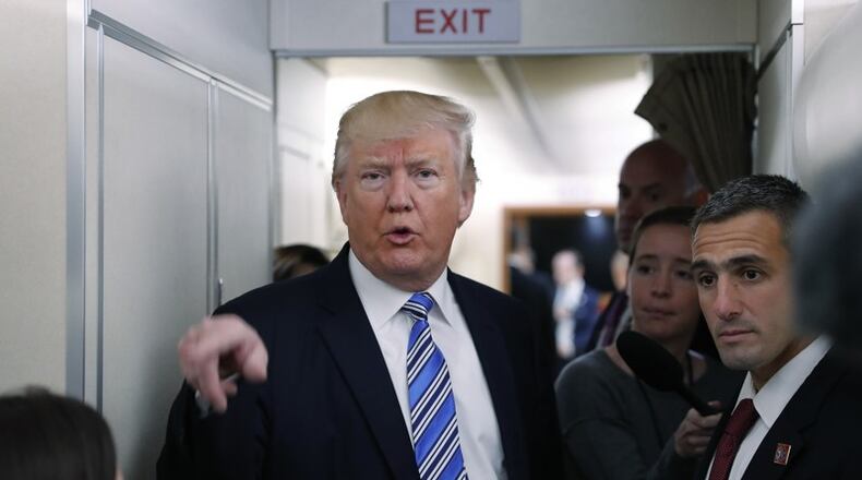 President Donald Trump speaks to members of the media aboard Air Force One before his departure from Andrews Air Force Base, Md., Saturday, May 13, 2017. Trump is traveling to Lynchburg, Va., to give the commence address for the Class of 2017 at Liberty University.