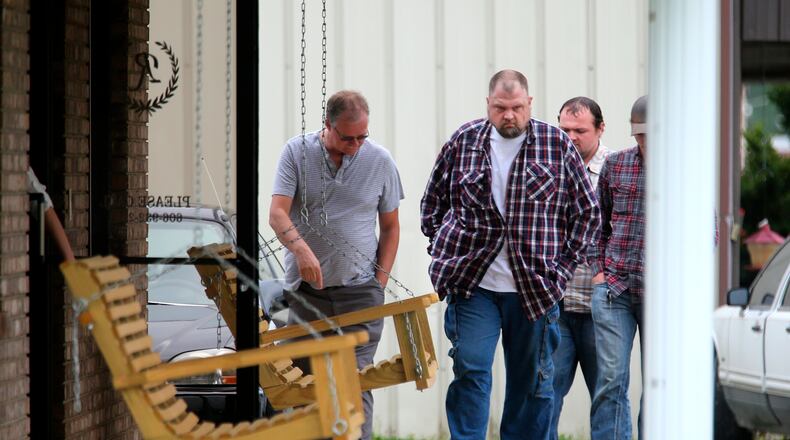 This April 27, 2016 photo, George 'Billy' Wagner, center, and his son's George Wagner IV, in back and Jake Wagner, at right, attend the funeral of Gary Rhoden, 38, in Greenup, KY. A custody dispute between two families that erupted into the massacre of eight people in rural southern Ohio started with a plan to kill just one of them, a young mother refusing to give up her daughter, a prosecutor said Monday, Oct. 4. 2022. George Wagner IV faces the death penalty if he’s convicted in the slayings of the Rhoden family near Piketon. His younger brother, Jake Wagner, last year pleaded guilty to shooting five of the victims, and is expected to testify against his brother as part of a deal with prosecutors that spared him from being sentenced to death. (Liz Dufour/The Cincinnati Enquirer via AP)