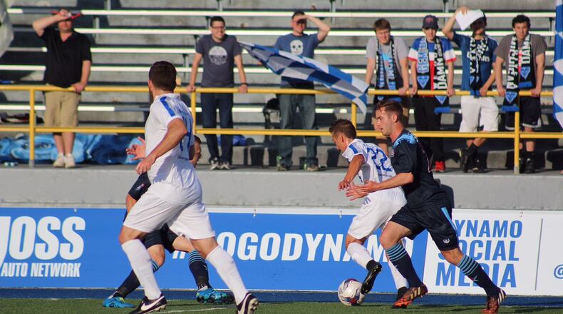 Dan Dwyer of the Dayton Dynamo pushes the ball up the field during a game at Welcome Stadium last season. TODD JACKSON/STAFF