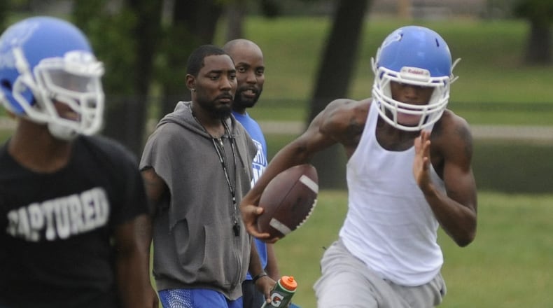 Darran Powell (middle) has been Dunbar’s football coach the last four seasons. MARC PENDLETON / STAFF