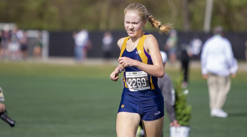 Oakwood senior Bella Butler presses toward the finish line Saturday to win the Division II state cross country championship at Fortress Obetz. CONTRIBUTED/Jeff Gilbert