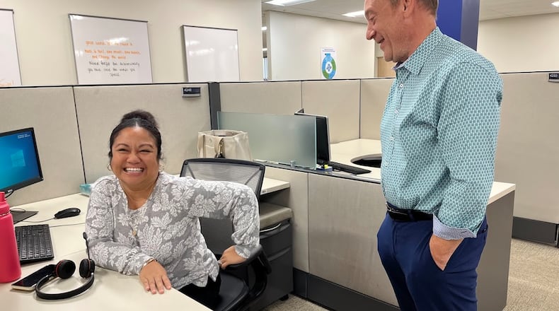 Timothy Mislansky, president and chief executive of Wright Patt Credit Union Inc., speaks with Kristine Massie, who works in the credit union's Beavercreek member help center. THOMAS GNAU/STAFF