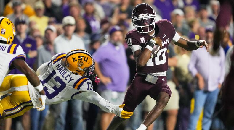 Texas A&M quarterback Marcel Reed (10) carries for a touchdown against LSU defensive back A.J. Haulcy (13) in the first half of an NCAA college football game, Saturday, Oct. 25, 2025 in Baton Rouge, La. (AP Photo/Gerald Herbert)