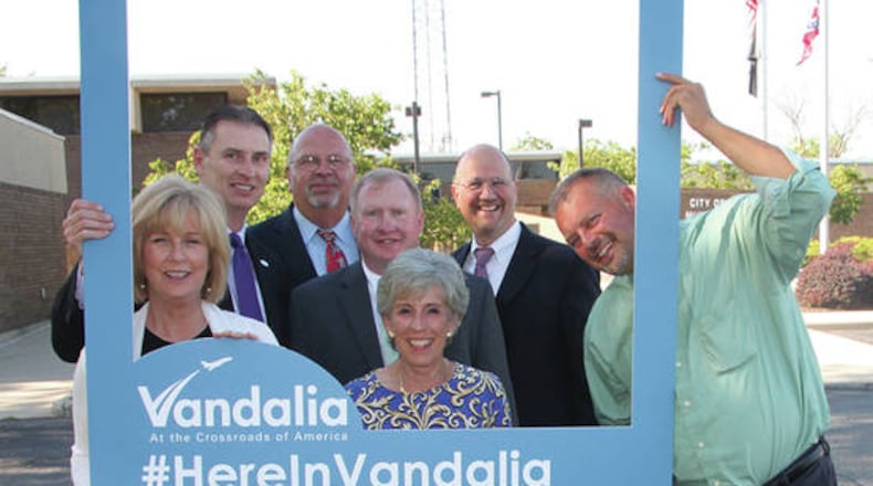 Vandalia City Council members show off a portable picture frame that will be used at Vandalia events in support of the city's #HereInVandalia social media project. Pictured left to right: Candice Farst, Richard Herbst, Bob Ahlers, Dave Lewis, Arlene Setzer, Mike Blakesly, and Dave Gearhard
