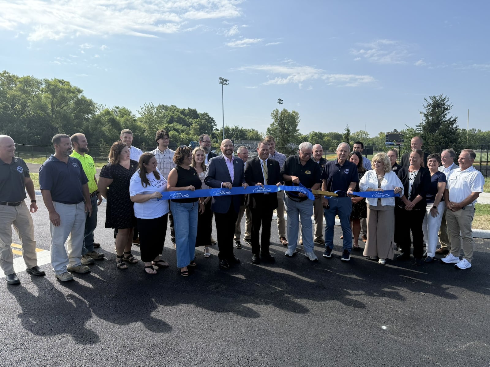 Centerville School Board President David Roer cuts the ribbon for the Dimco Way extension as school board, city and state officials look on Monday, Aug. 11, 2025. The road was extended approximately 2,000 feet from South Suburban Road near Clyo Road to Centerville High School to help reduce traffic congestion and improve roadway access. CONTRIBUTED