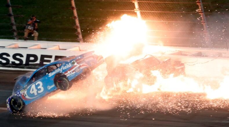 Driver Aric Almirola (43) crashes into Danica Patrick (10) and Joey Logano (22) during the NASCAR Monster Cup auto race at Kansas Speedway in Kansas City, Kan., Saturday, May 13, 2017. (AP Photo/Colin E. Braley)