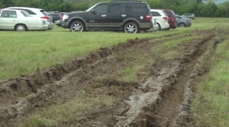 Some cars needed help to get out of the Vectren Dayton Air Show’s P-Lot for pavilion and chalet ticket holders in this 2015 photo. Spectators reported having to walk through 4-inch deep puddles and jump over foot-deep mud ruts in what was a grass field. JANEL SKERL / CONTRIBUTED)
