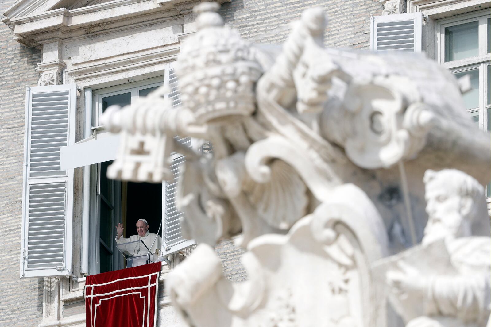 FILE - Pope Francis waves during the Angelus noon prayer delivered from his studio window overlooking St. Peter's Square, at the Vatican, Oct. 4, 2020. (AP Photo/Gregorio Borgia, File)