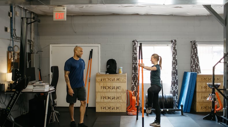Jason Harrison, left, goes through a workout at Present Tense Fitness. Sarah Rose Photography