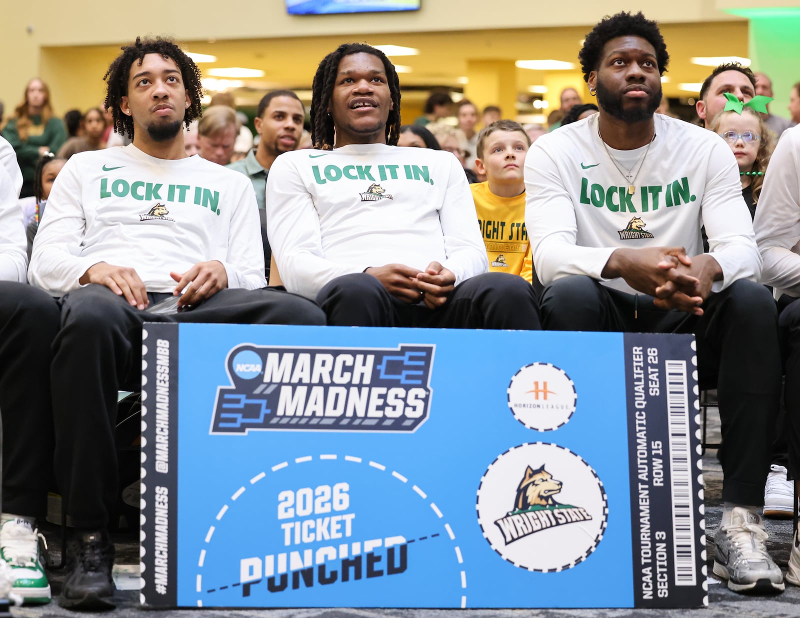 From left to right, Wright State's Logan Woods, Andrea Holden and Michael Imariagbe watch during a Selection Sunday watch party on Sunday, March 15 at the university's Student Union in Fairborn. BRYANT BILLING / STAFF