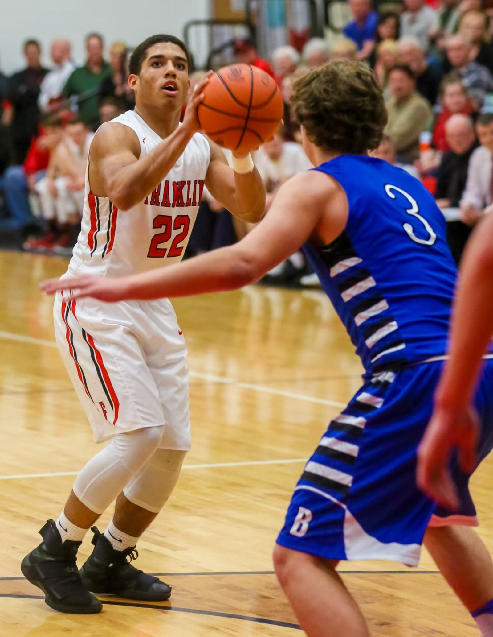 Franklin guard Ryan Montgomery (22) prepares to take a shot over Brookville’s Dalton Stewart (3) during Tuesday night’s game at Darrell Hedrick Gymnasium in Franklin. GREG LYNCH/STAFF