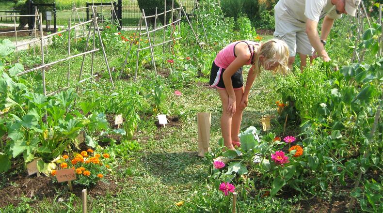 A parent and child gardening at a Five Rivers MetroParks. FIVE RIVERS METROPARKS