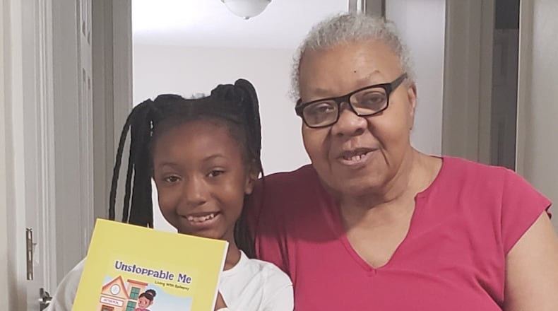 Jordynn Farley (left) of Trotwood holds book that she wrote withe the editing assistance of her grandmother, Francis Marr, a retired Dayton teacher. CONTRIBUTED PHOTOS