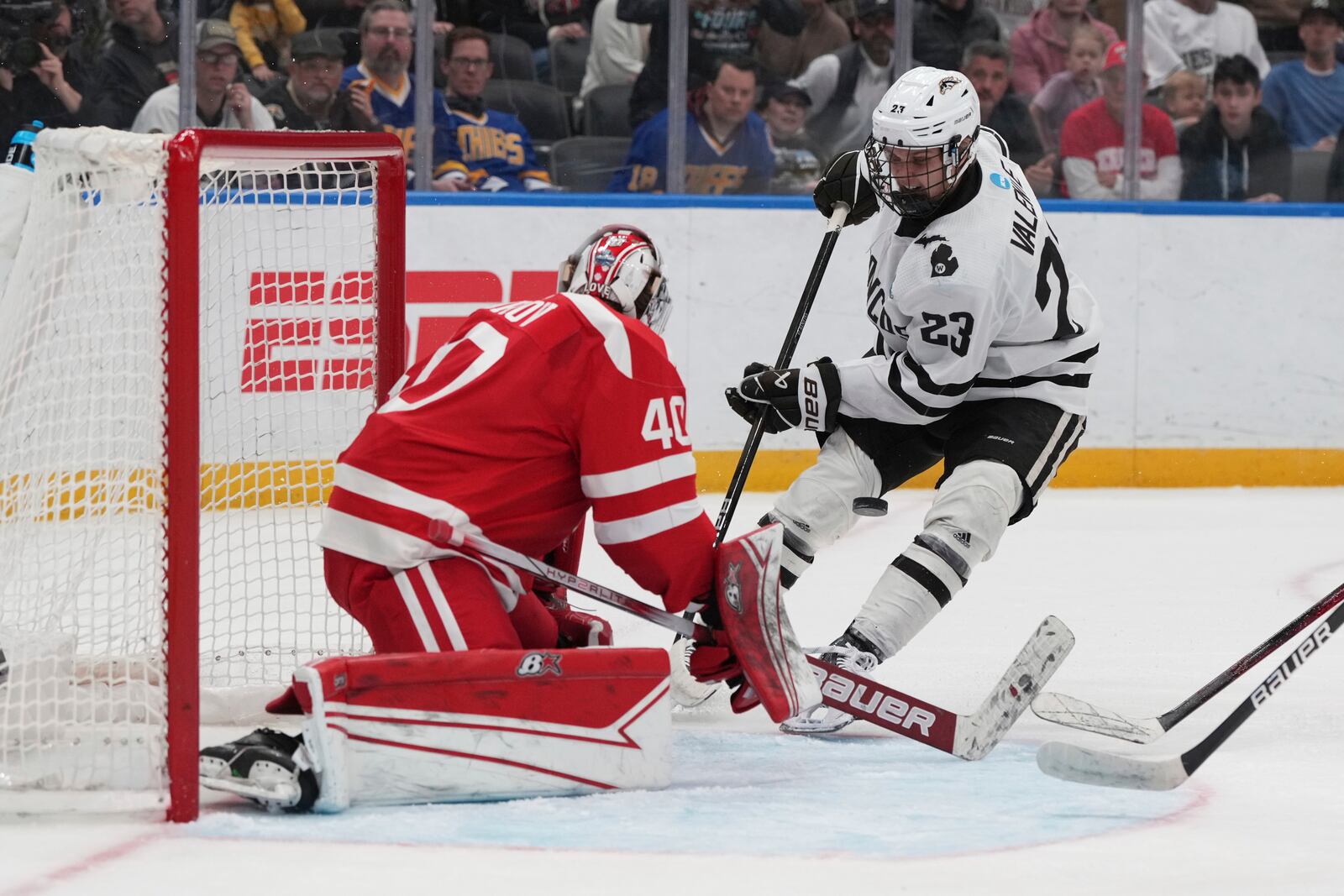 Boston University goaltender Mikhail Yegorov, left, deflects a shot from Western Michigan's Liam Valente (23) during the first period in the championship game of the NCAA Frozen Four men's college hockey tournament, Saturday, April 12, 2025, in St. Louis (AP Photo/Jeff Roberson)