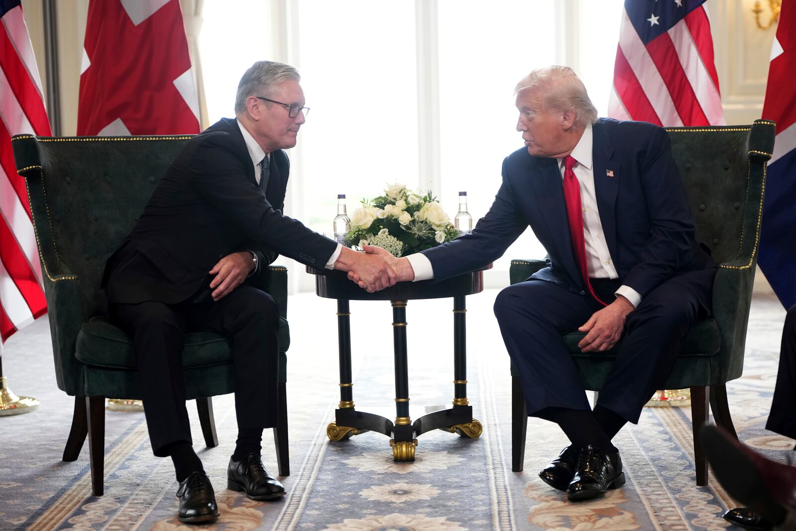 President Donald Trump shakes hands as he meets with Britain's Prime Minister Keir Starmer, left, at Trump Turnberry golf club on Monday, July 28, 2025 in Turnberry, Scotland. (Christopher Furlong/Pool Photo via AP)
