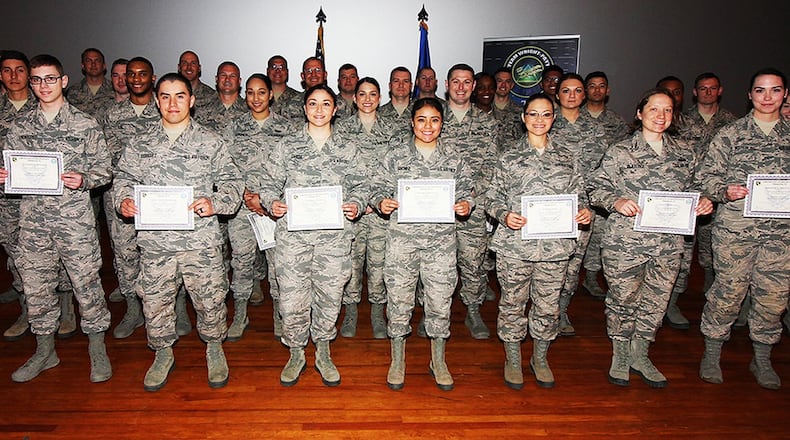 Col. Bradley McDonald, 88th Air Base Wing and installation commander, (left), and Chief Master Sgt. Paula Eischen, 88th Air Base Wing command chief (right), celebrated the newest Team Wratt-Patt enlisted promotees during a ceremony at the base theater, Wright-Patterson Air Force Base, Ohio, April 30, 2018. (U.S. Air Force photo/Thomas Lewis)