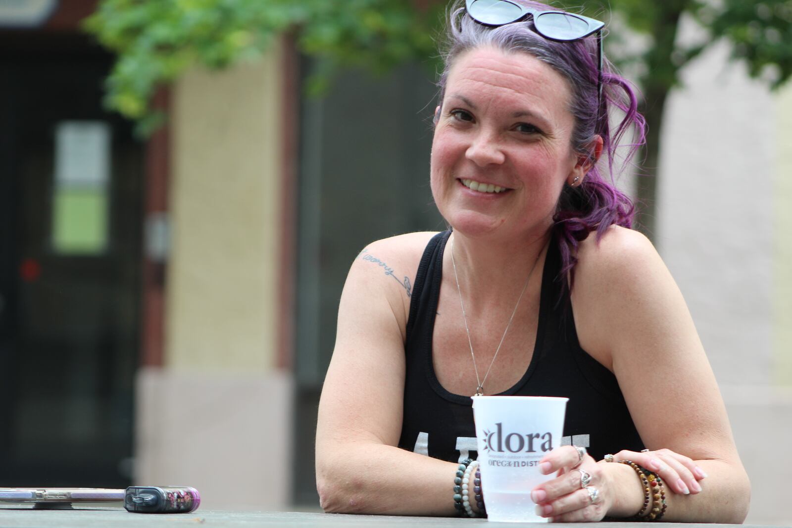 Kelly Tipton, 42, of Dayton, enjoys a drink in the Oregon District Designated Outdoor Refreshment Area (DORA) on Friday, May 19, 2023. CORNELIUS FROLIK / STAFF