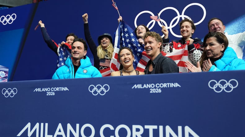 Madison Chock and Evan Bates of the United States react to their scores after competing during the figure skating ice dance team event at the 2026 Winter Olympics, in Milan, Italy, Friday, Feb. 6, 2026. (AP Photo/Stephanie Scarbrough)