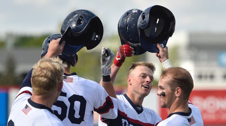 Dayton celebrates a home run by Connor Echols, second from right, against Saint Joseph’s on April 26, 2019, in Dayton. Photo by Erik Schelkun