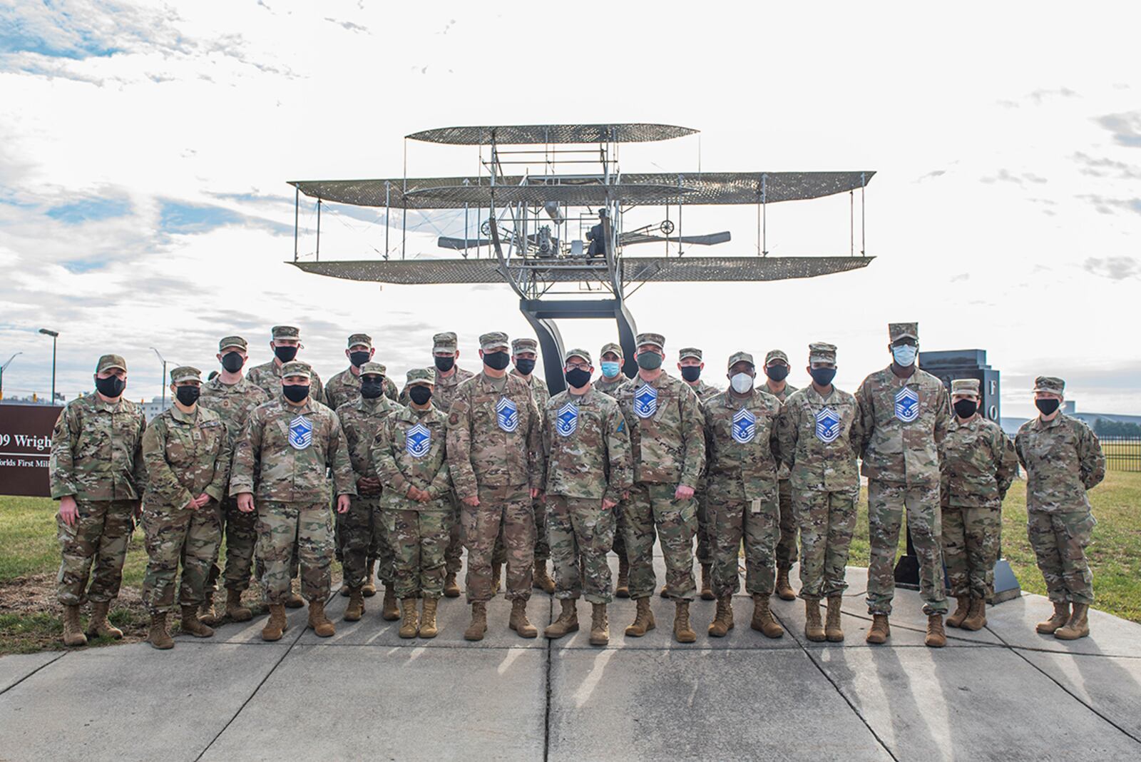 Wright-Patterson Air Force Base’s chief master sergeant selects gather for a group photo Dec. 9 in front of the Wright Flyer sculpture near Gate 1 on Area B. U.S. AIR FORCE PHOTO/WESLEY FARNSWORTH