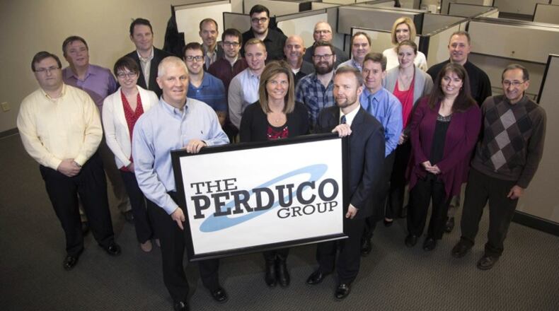 A 2016 photo of Beavercreek’s Perduco Group workforce. The company that year was more than doubling its space off Pentagon Boulevard. The firm specializes in “big, ugly data, ” in defense, in health care and yes, in sports and fantasy football. Execs with the sign from the left are: Chris Mason VP Operations, Toyzanne Mason, President, and Stephen Chambal, VP.