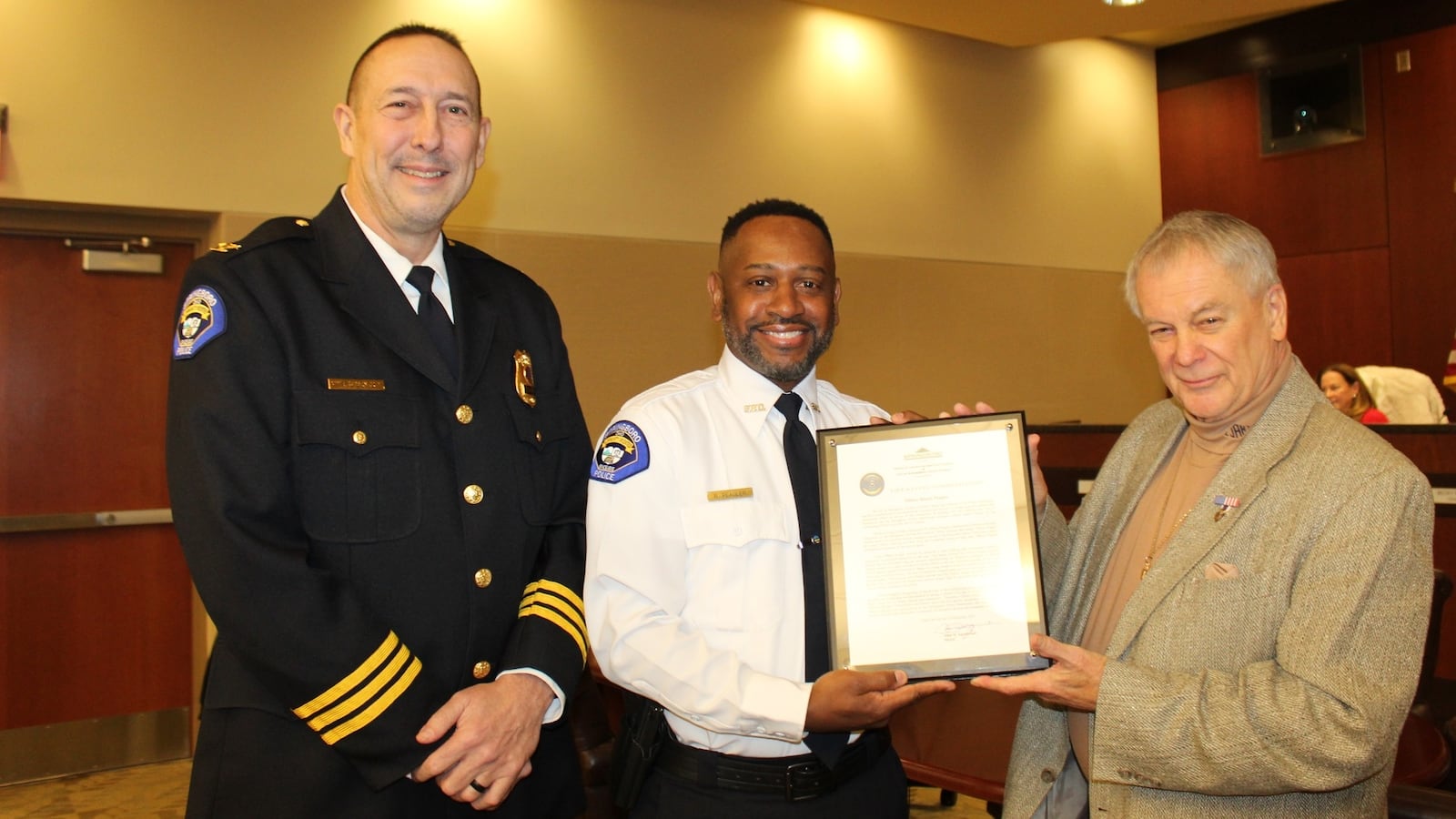 Springboro City Council honored officer Randy Peagler, center, with a life saving award Dec. 4, 2025, for his actions during an Oktoberfest event in the city. At left is Police Chief Dan Bentley and Mayor John Agenbroad is at right. CONTRIBUTED