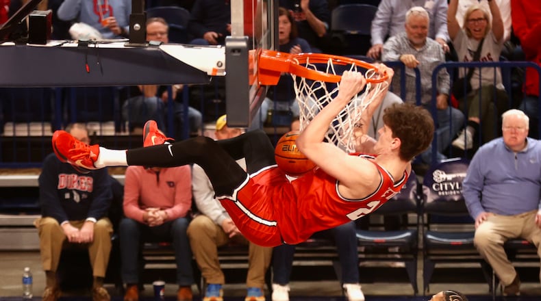 Dayton's Amaël L'Etang hangs on the rim after a dunk against Duquesne and earns a technical foul in the second half on Tuesday, Jan. 21, 2025, at the UPMC Cooper Fieldhouse in Pittsburgh. David Jablonski/Staff