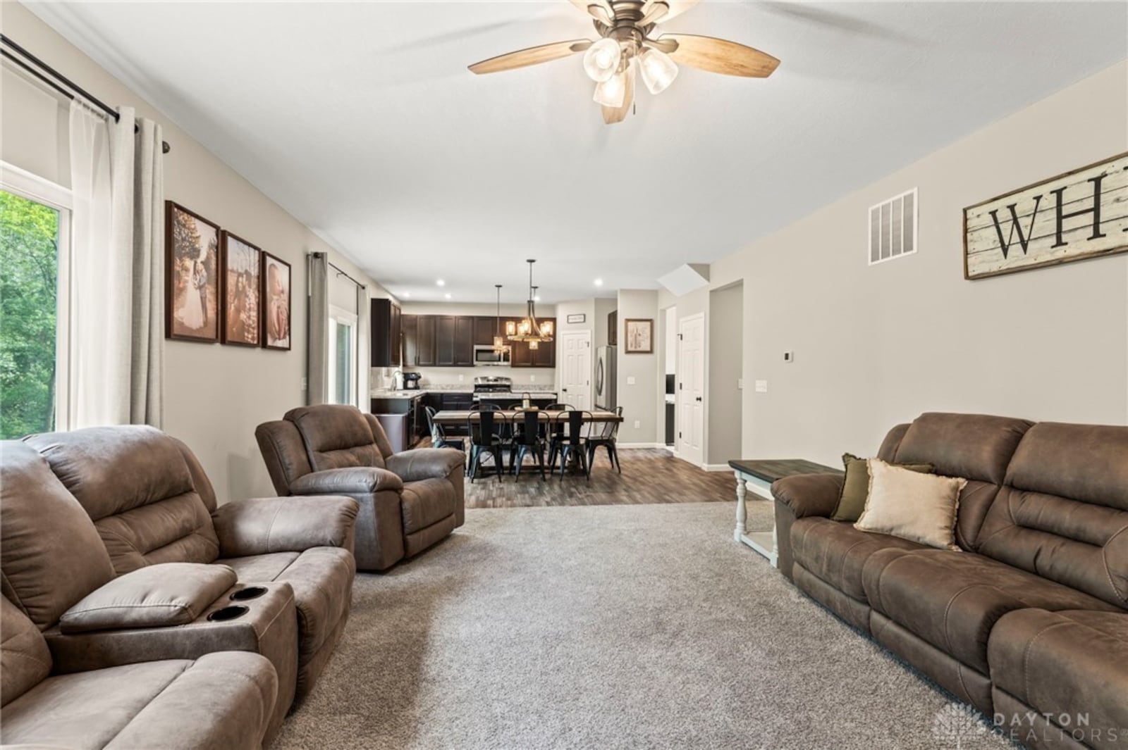 The open concept kitchen, dining and family rooms have carpeting and LVT flooring. The kitchen features stainless appliances and an island. CONTRIBUTED