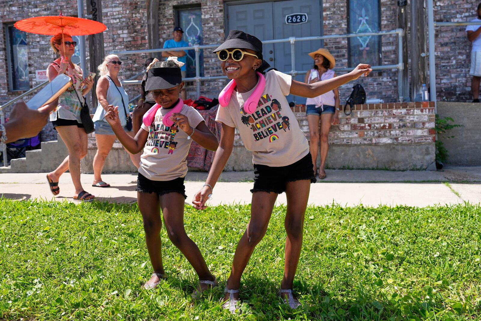 Kelsea and Kennedy Branford watch during a Juneteenth parade Thursday, June 19, 2025, in Galveston, Texas. (AP Photo/David J. Phillip)