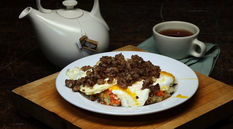 Sausage and onion top fried eggs in this pizza-inspired breakfast dish, all resting on crisped shredded potatoes. (Terrence Antonio James/Chicago Tribune/TNS)