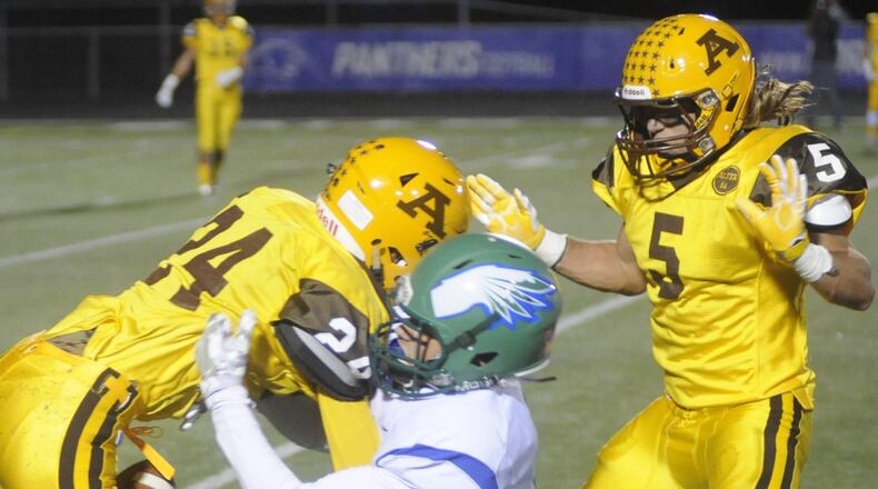 Alter’s Michael Beam (left) and teammate Lane Harshbarger (right) converge on CJ receiver Jake Kinnear. Alter hosted Chaminade Julienne at Springboro in a Week 10 high school football game on Friday, Oct. 28, 2016. MARC PENDLETON / STAFF