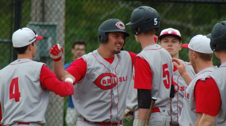 Carlisle’s Reece Human (center) is greeted at home plate after leading off the second inning with a home run Wednesday at Waynesville. CONTRIBUTED PHOTO BY JOHN CUMMINGS
