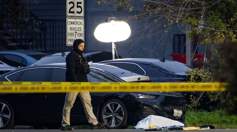 Investigators examine the scene of a mass shooting Sunday, Nov. 30, 2025, in Stockton, Calif. (AP Photo/Ethan Swope)