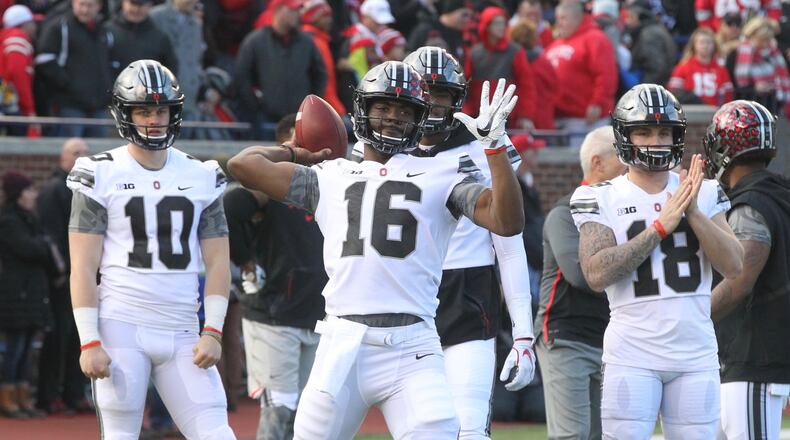 Ohio State quarterback J.T. Barrett warms up before a game against Michigan on Saturday, Nov. 25, 2017, at Michigan Stadium in Ann Arbor, Mich.