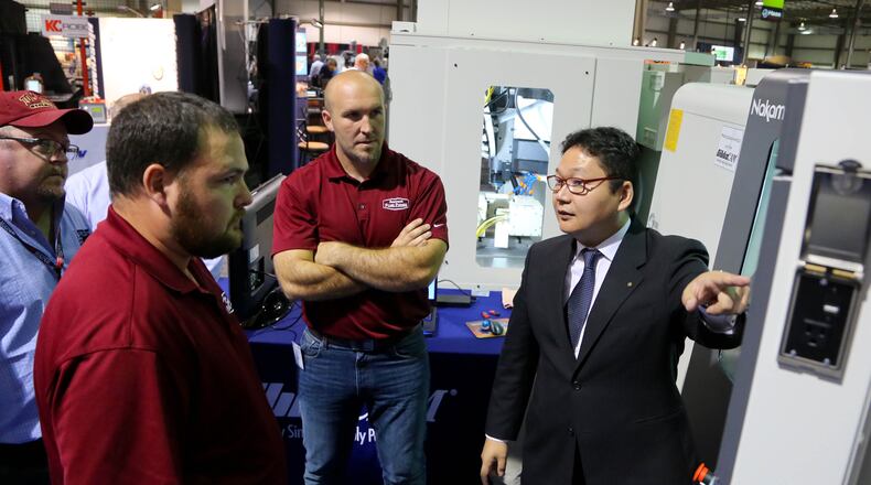 Nakamura-Tome Product Manager Jundi Oyama demonstrates a CNC Multi-Axis Mill Turn Machine at the 2015 DRMA Advanced Manufacturing and Technology Trade Show. This year’s event begins Wednesday at the Dayton Convention Center. JIM WITMER/STAFF